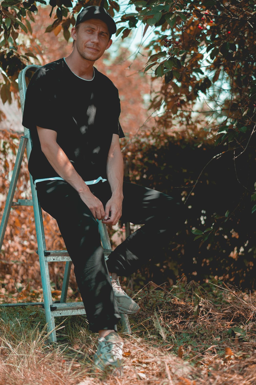 a man sitting on a ladder