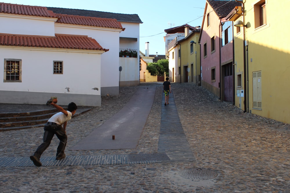 a man taking a picture of a man walking on a street