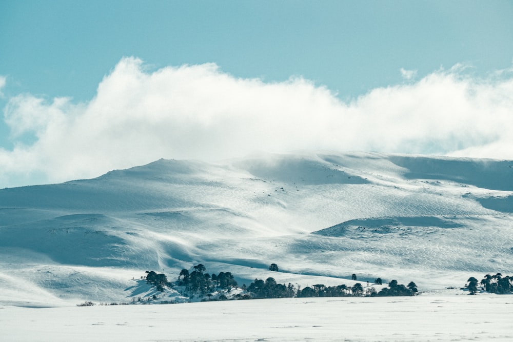 a snowy landscape with clouds