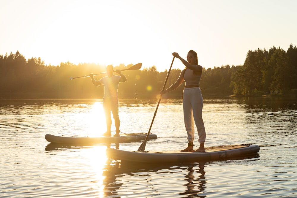 a couple of people on a paddle board in the water