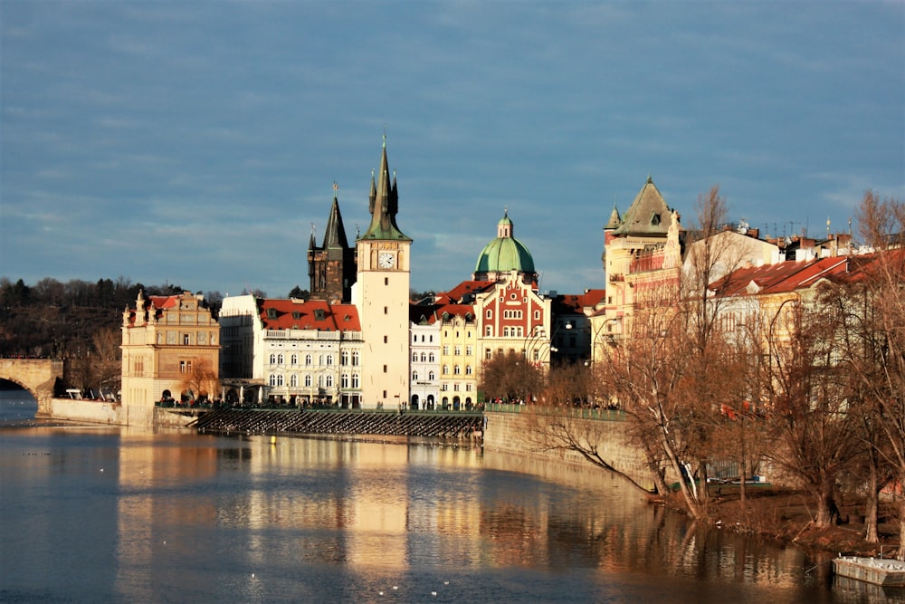 a river with a bridge and buildings along it