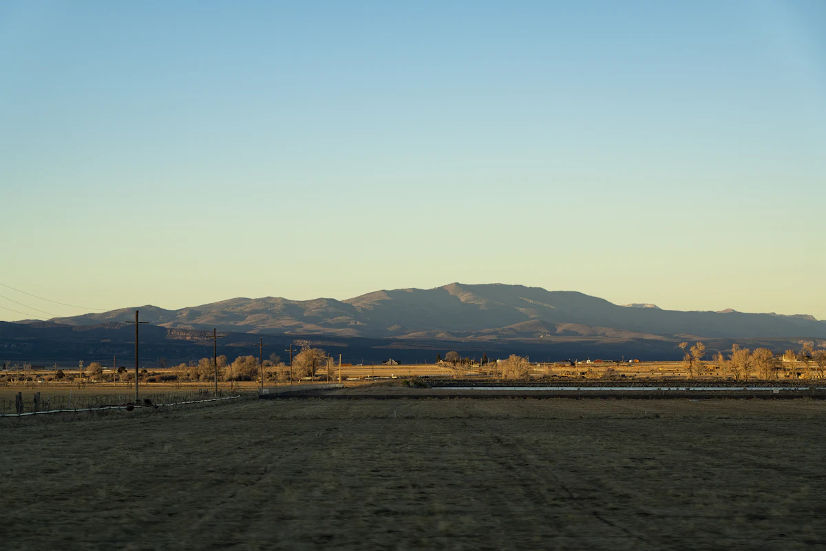 Flat farmland near Panguitch, Utah, with low mountains in evening light
