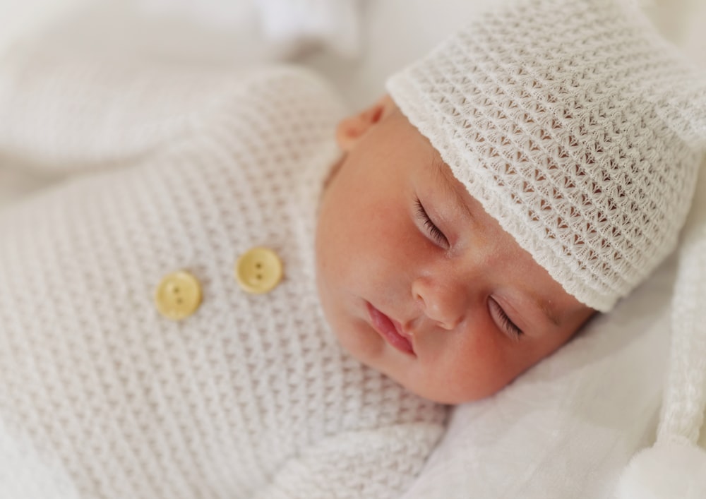 a baby with a white hat
