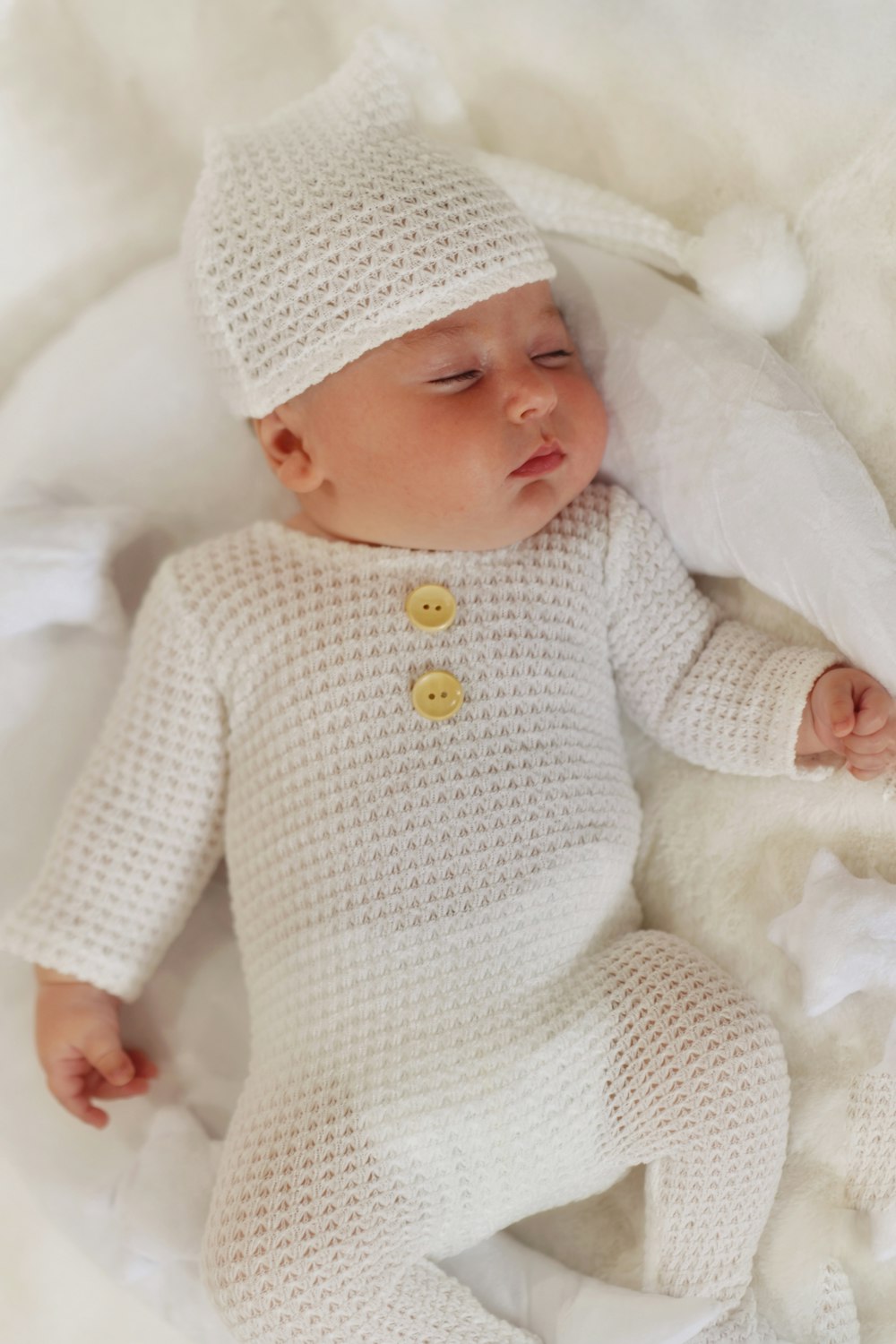 a baby wearing a white outfit