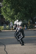A group of enthusiastic students practicing marching band formations outdoors.