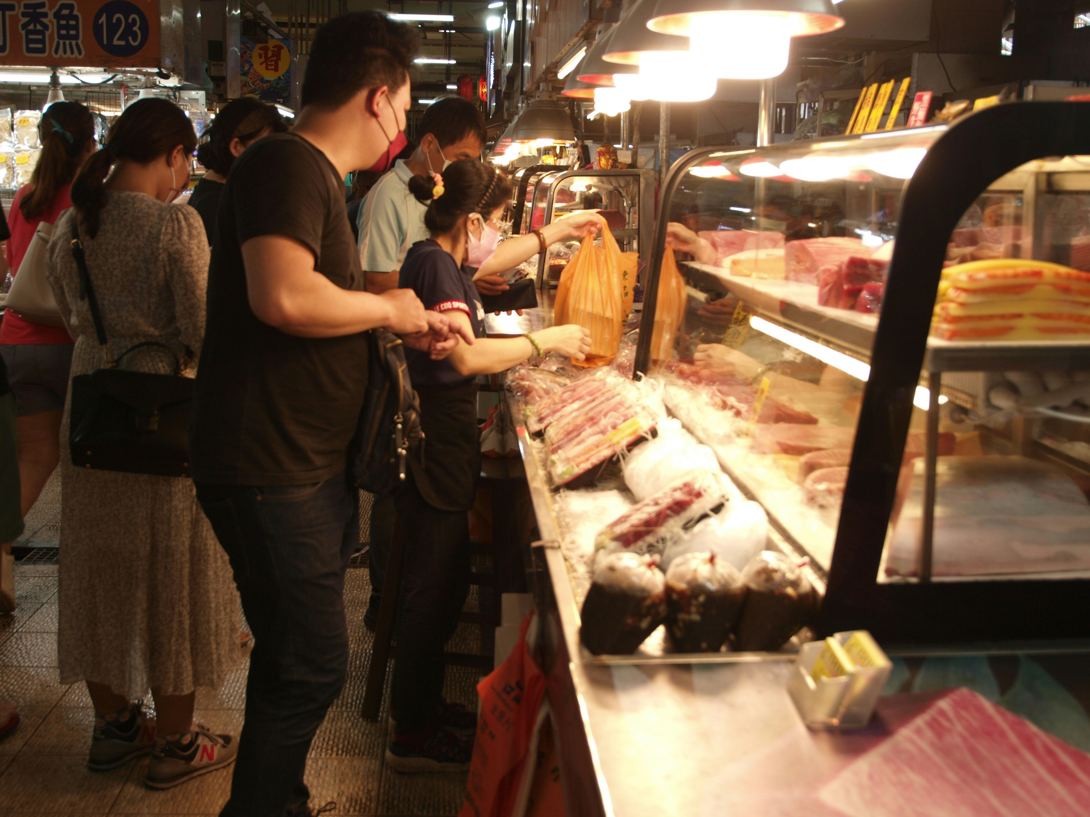 People standing around a food counter