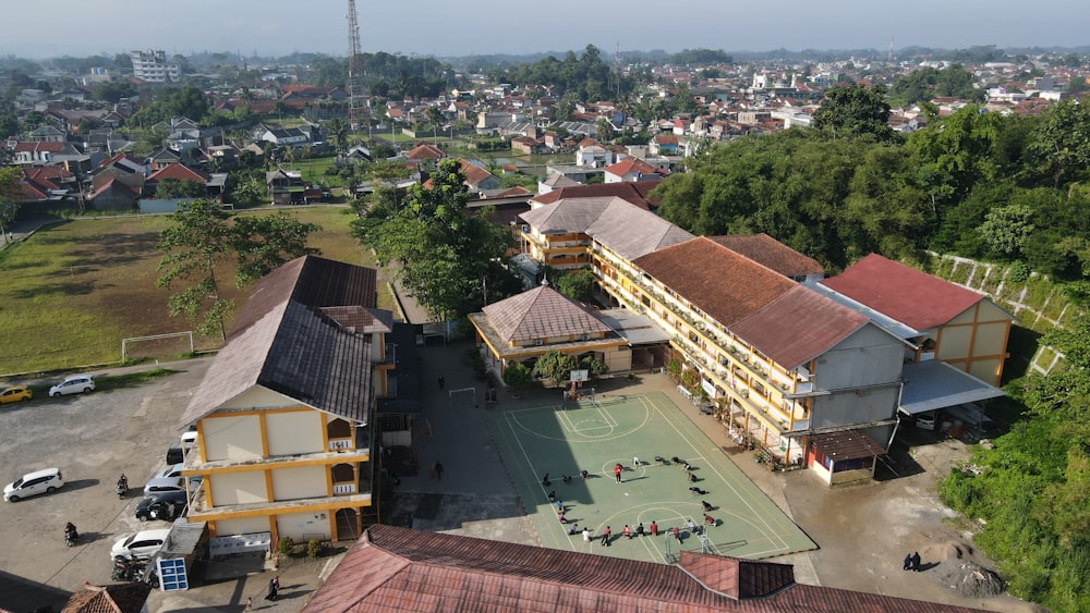 a group of buildings with trees and a road in the front