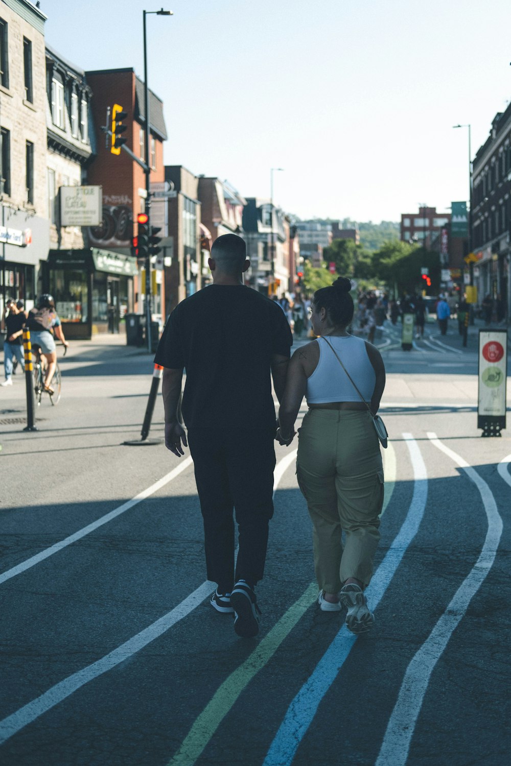 a man and woman walking down a street