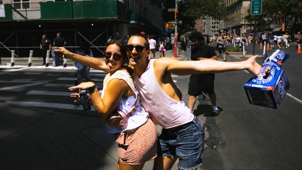 a man and woman posing for a picture on a street