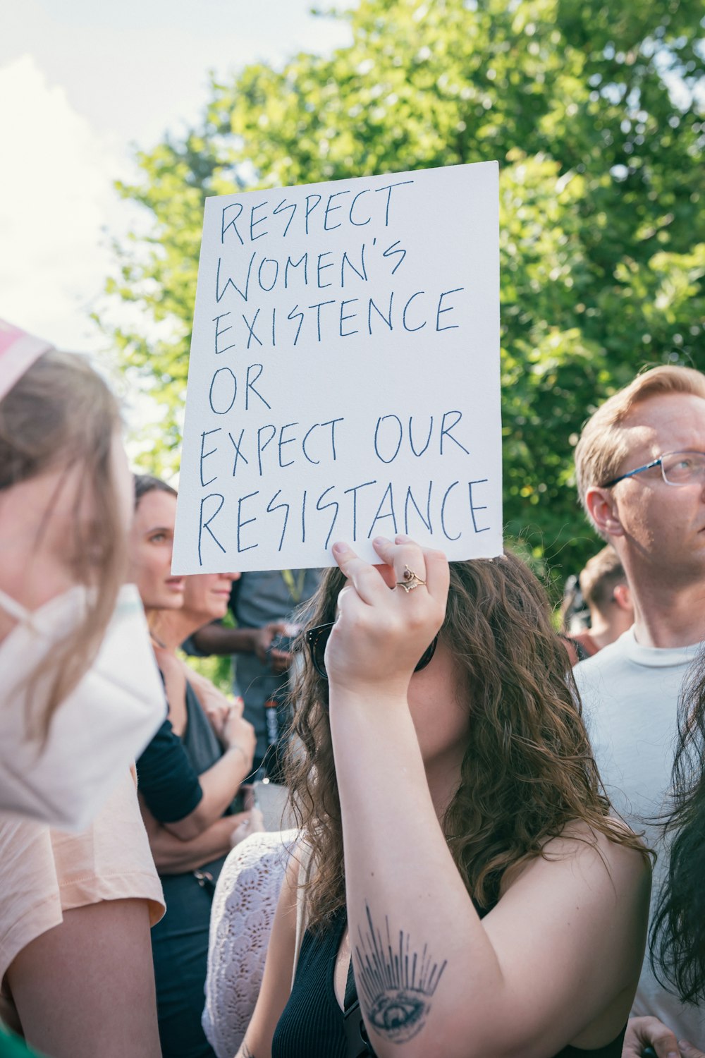 a woman holding a sign