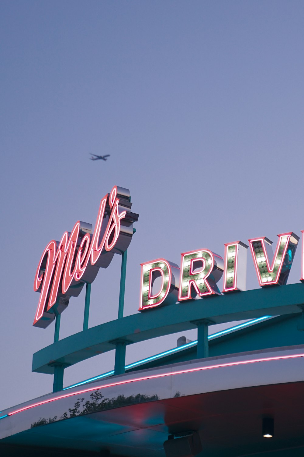 a plane flying over a large sign