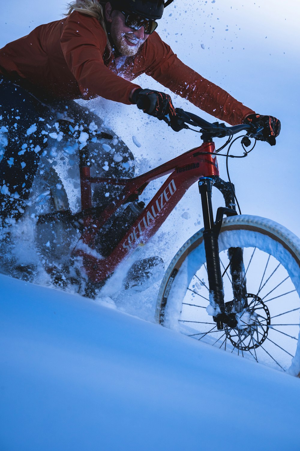 a person riding a bike in the snow