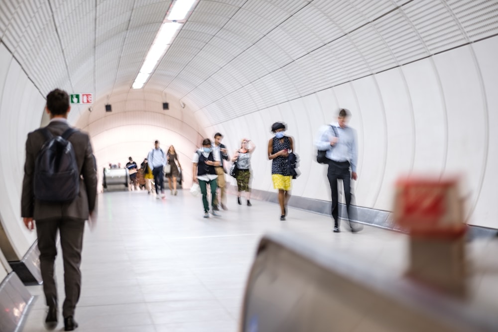 a group of people walking in a hallway