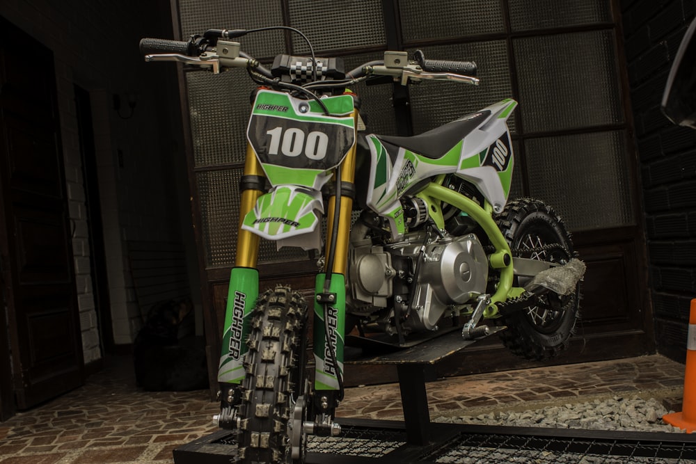 a green motorcycle parked on a stand