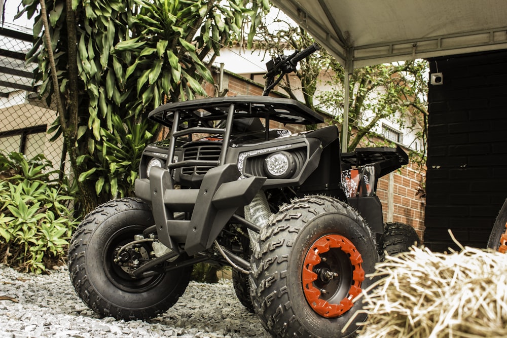 a black vehicle with orange rims