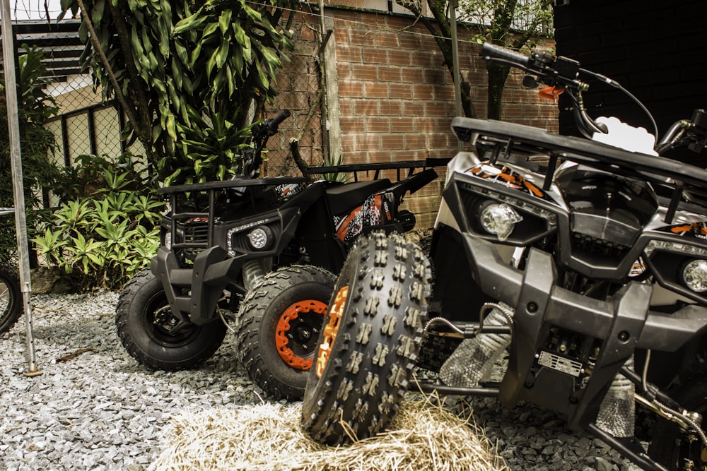 a couple of black and orange scooters parked next to each other