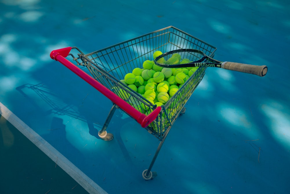 a shopping cart full of balls