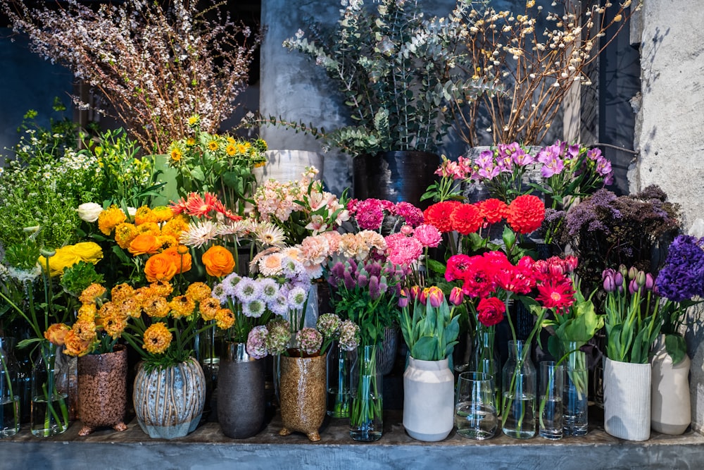 a group of flowers in vases