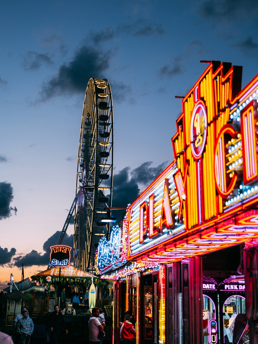 a colorful building with a ferris wheel in the background