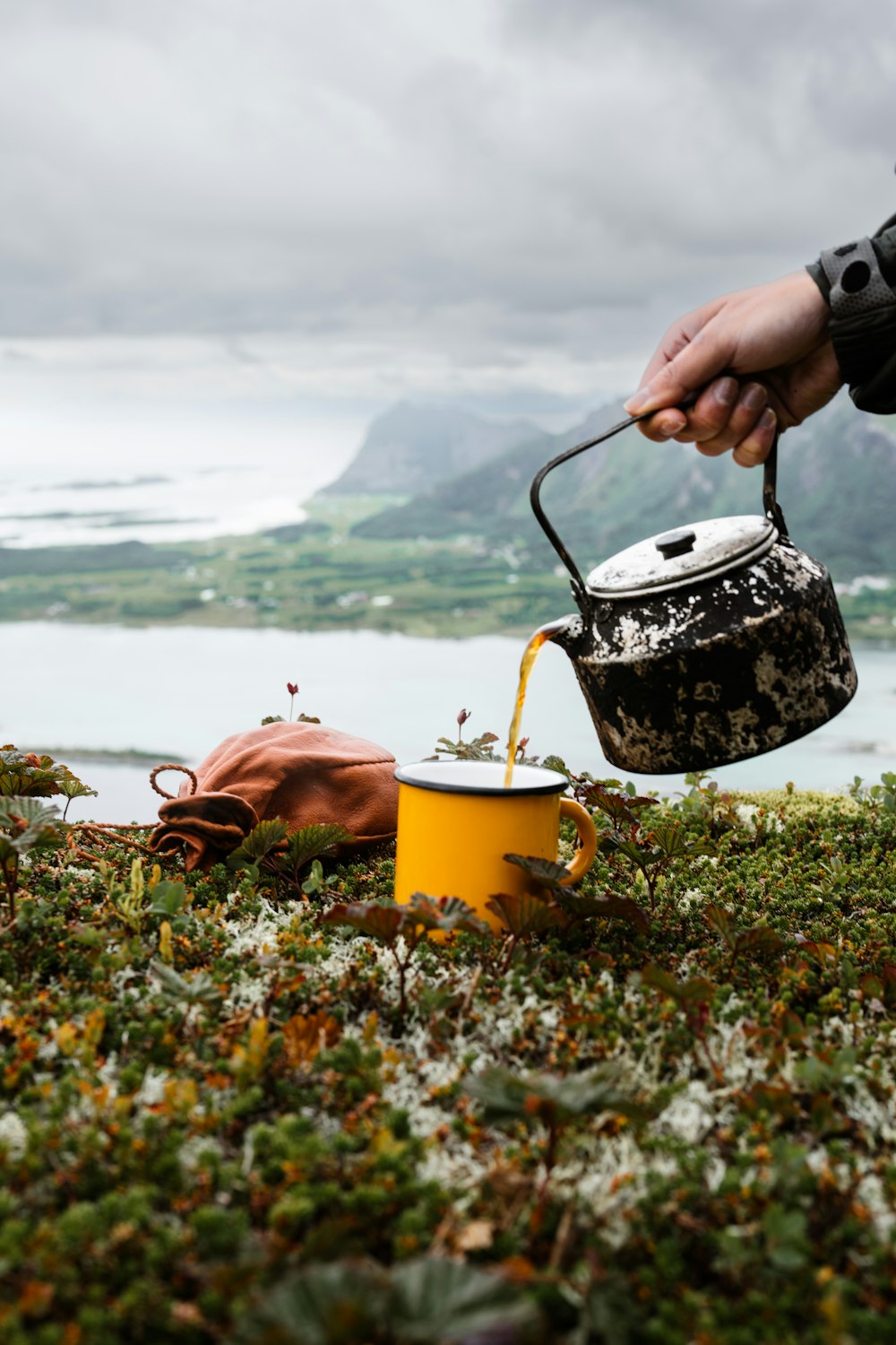 a person pouring a liquid into a bucket