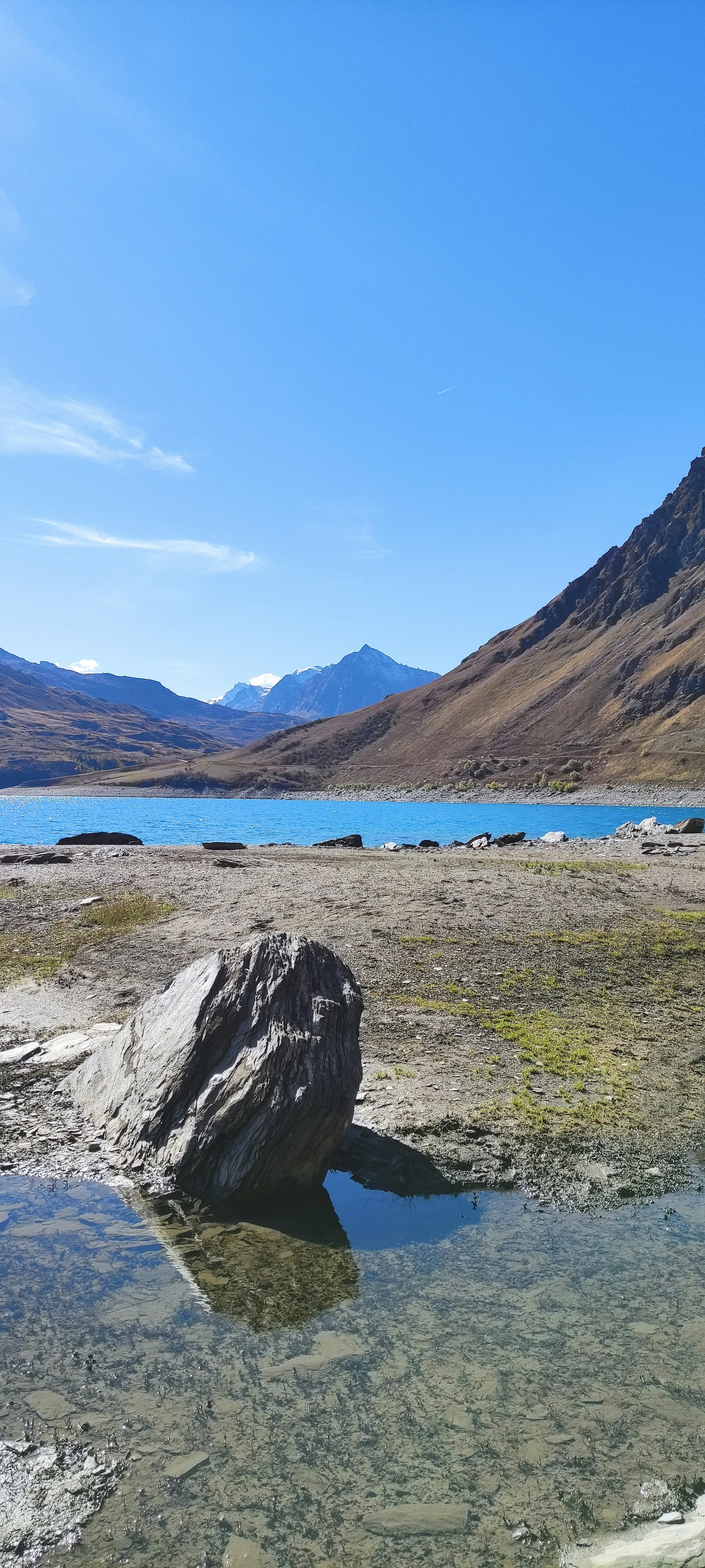 a body of water with mountains in the background