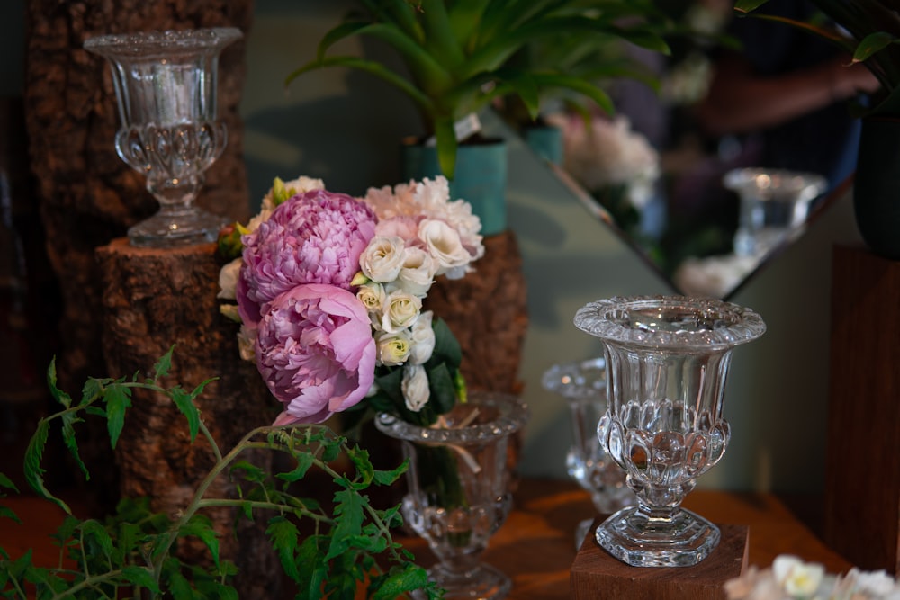 a table with glasses and flowers