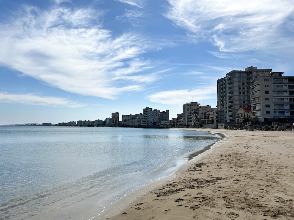 a beach with buildings in the background