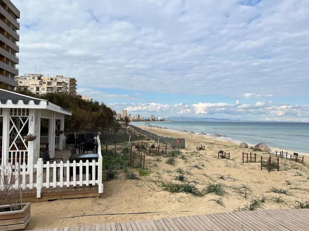 a beach with a fence and buildings