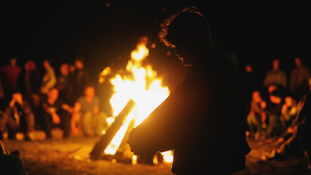 a person sitting in front of a fire