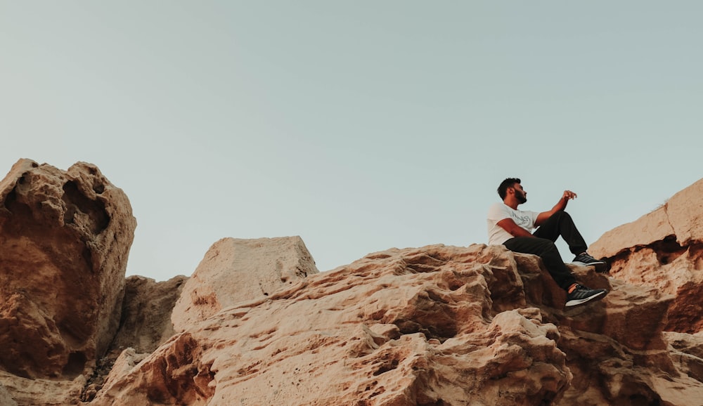 a man sitting on a rock