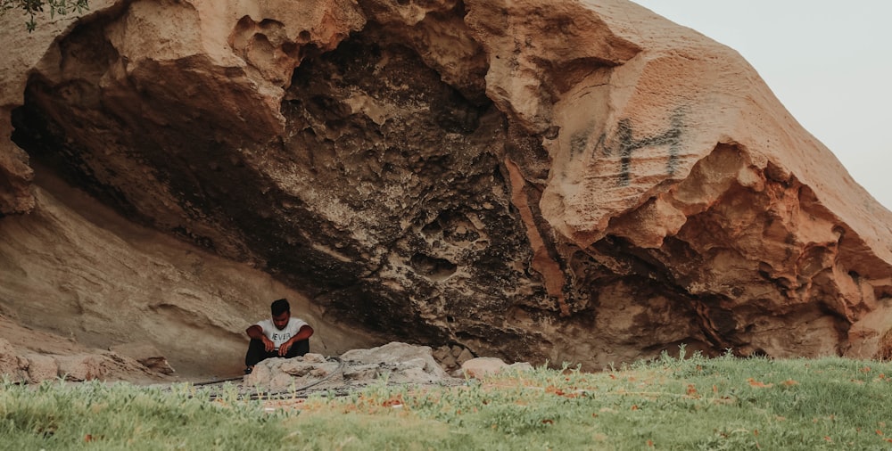 a person sitting on a rock