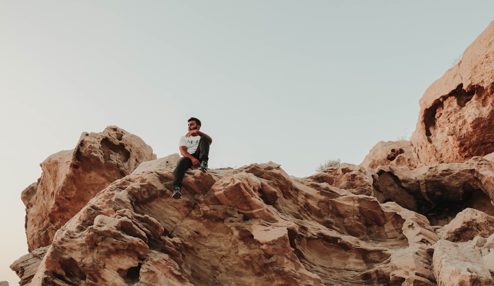 a man sitting on a rock