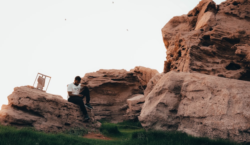 a person sitting on a rock