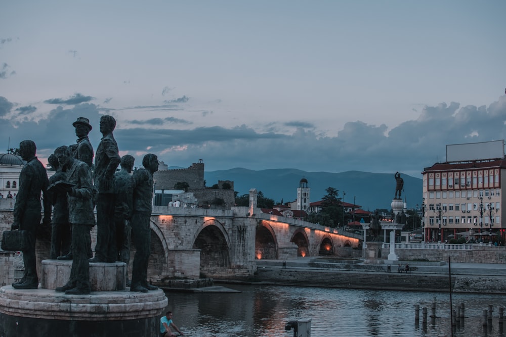 a group of statues by a river