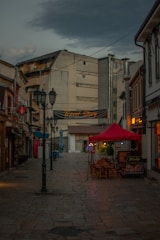 a brick road with buildings on either side of it