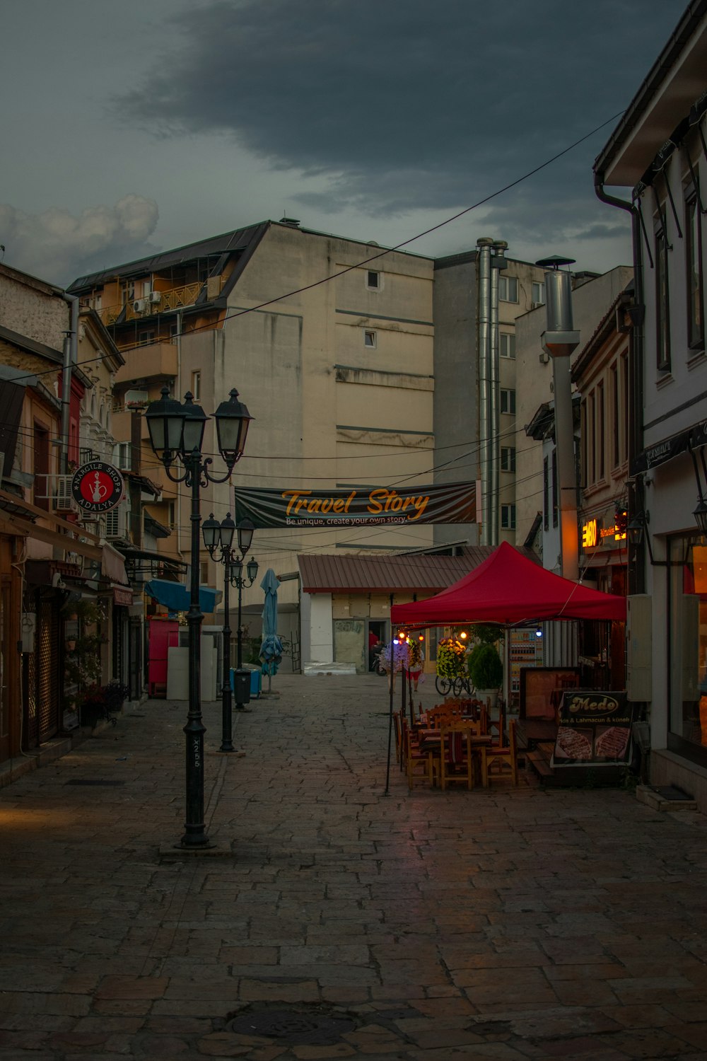 a brick road with buildings on either side of it