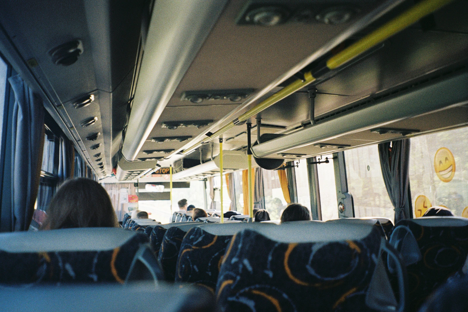 The empty interior of a public bus looking down the aisle