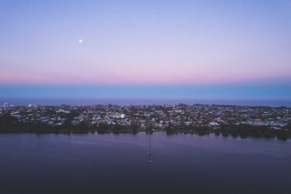 a body of water with a city in the background