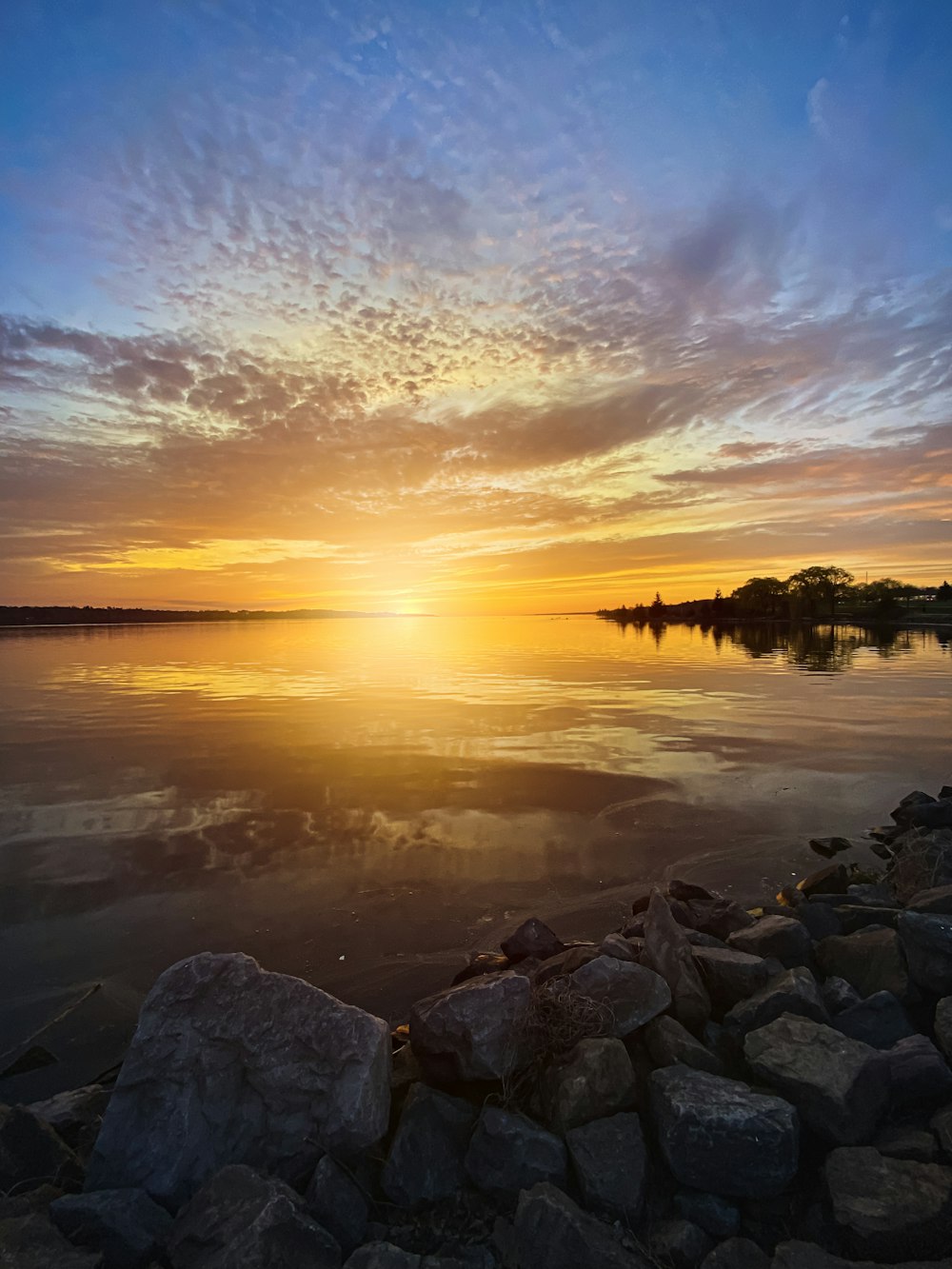 a rocky beach with a sunset