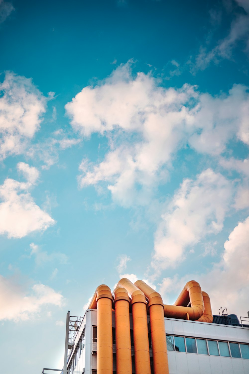 a building with a blue sky and clouds