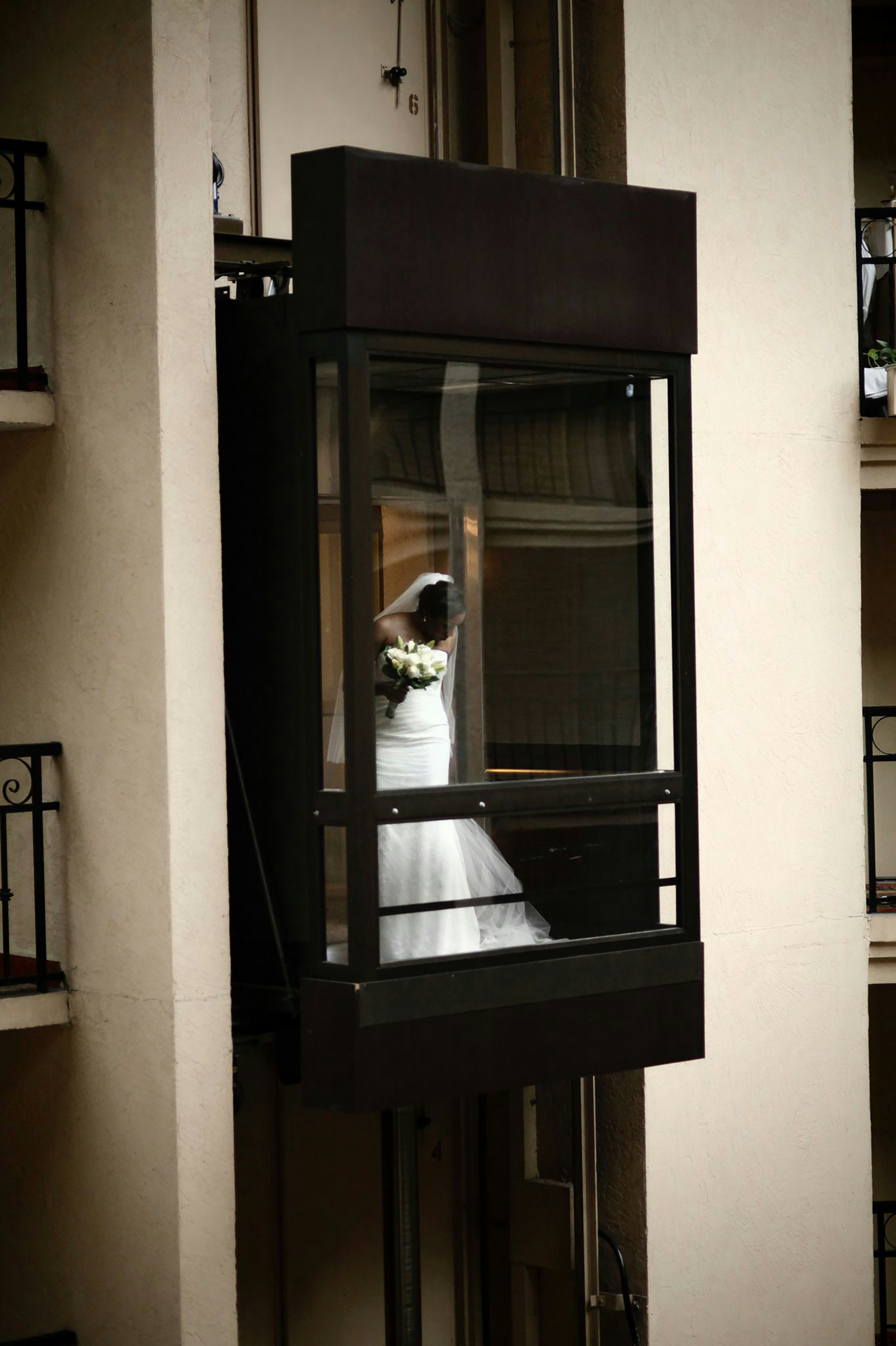 a bride and groom in a window