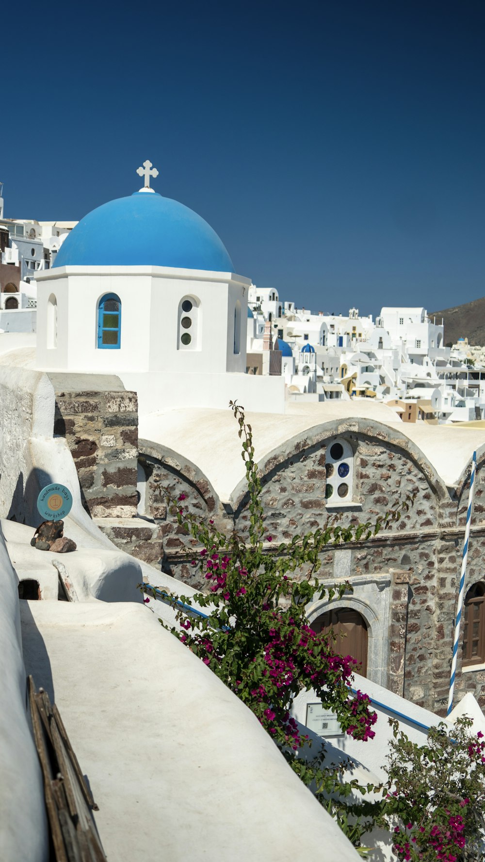 a white building with a blue dome and a cross on top