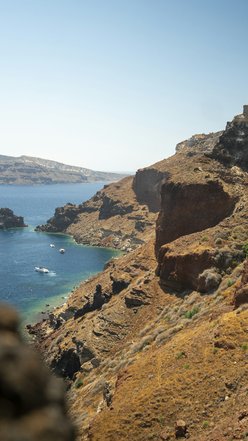 a rocky cliff overlooking a body of water