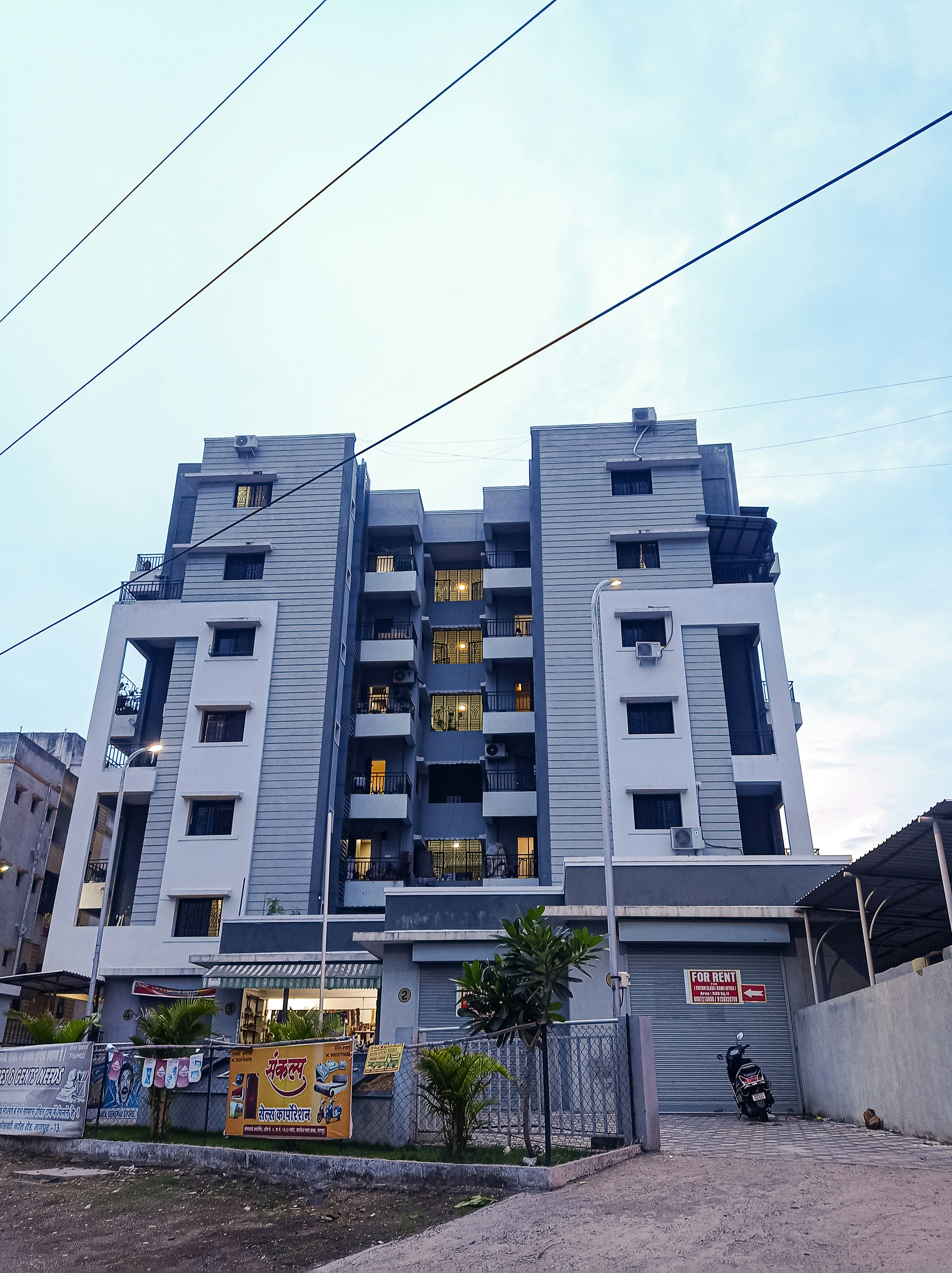 a building with wires and a fence