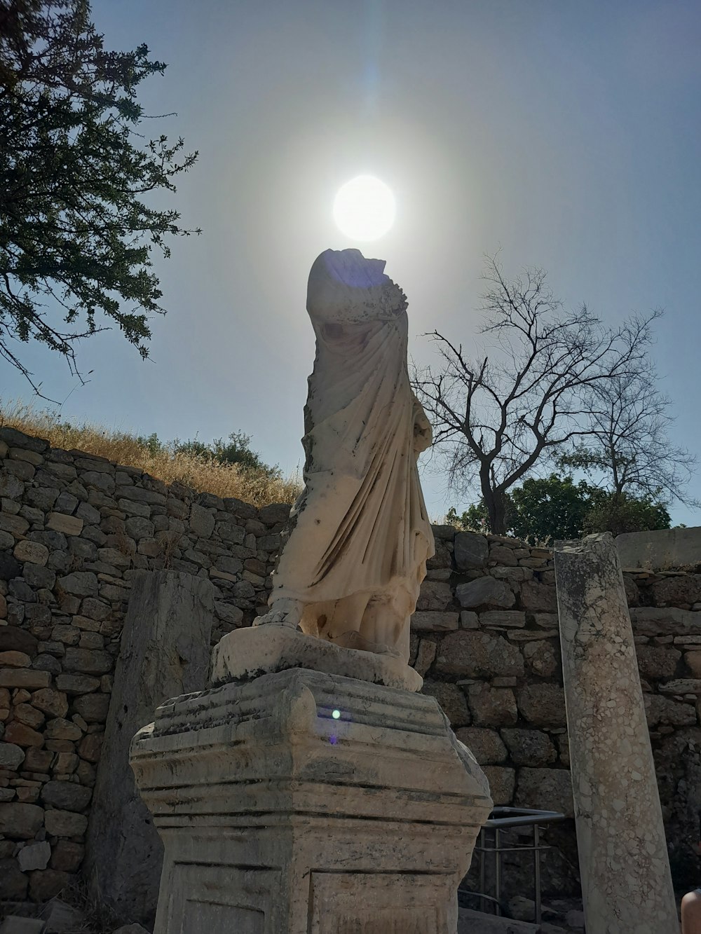 a stone statue of a person with a hat and a beard