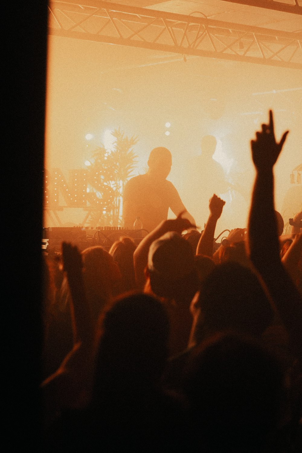 a group of people in front of a stage with a crowd watching