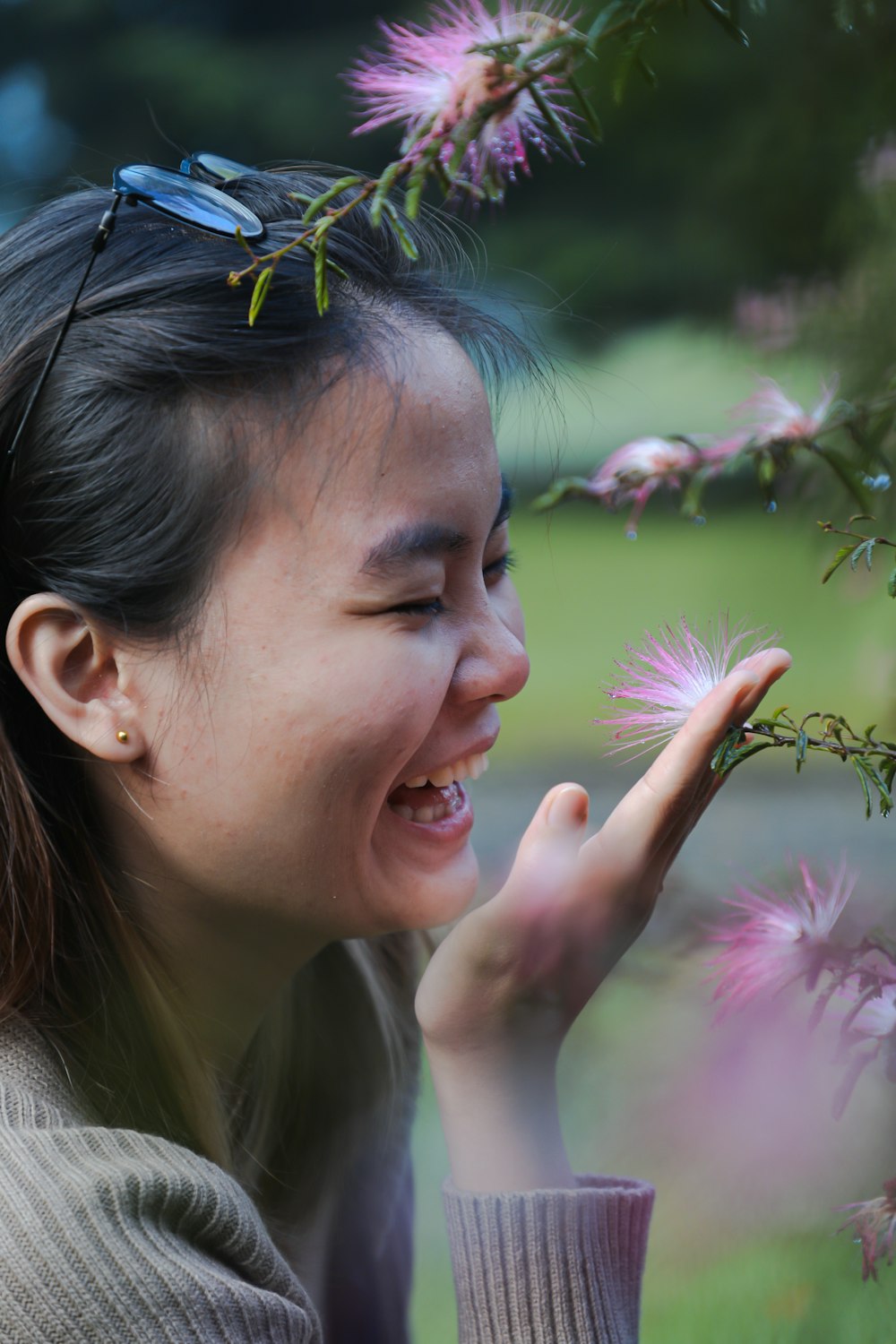 a woman smelling a flower