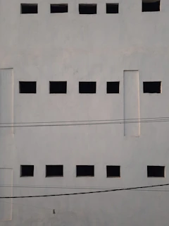 a white wall with black squares