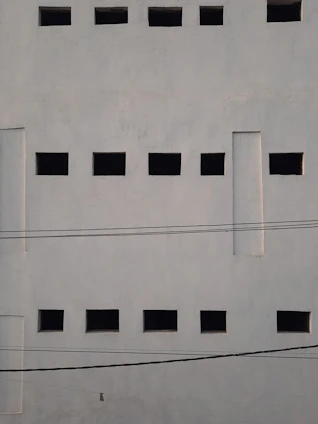 a white wall with black squares