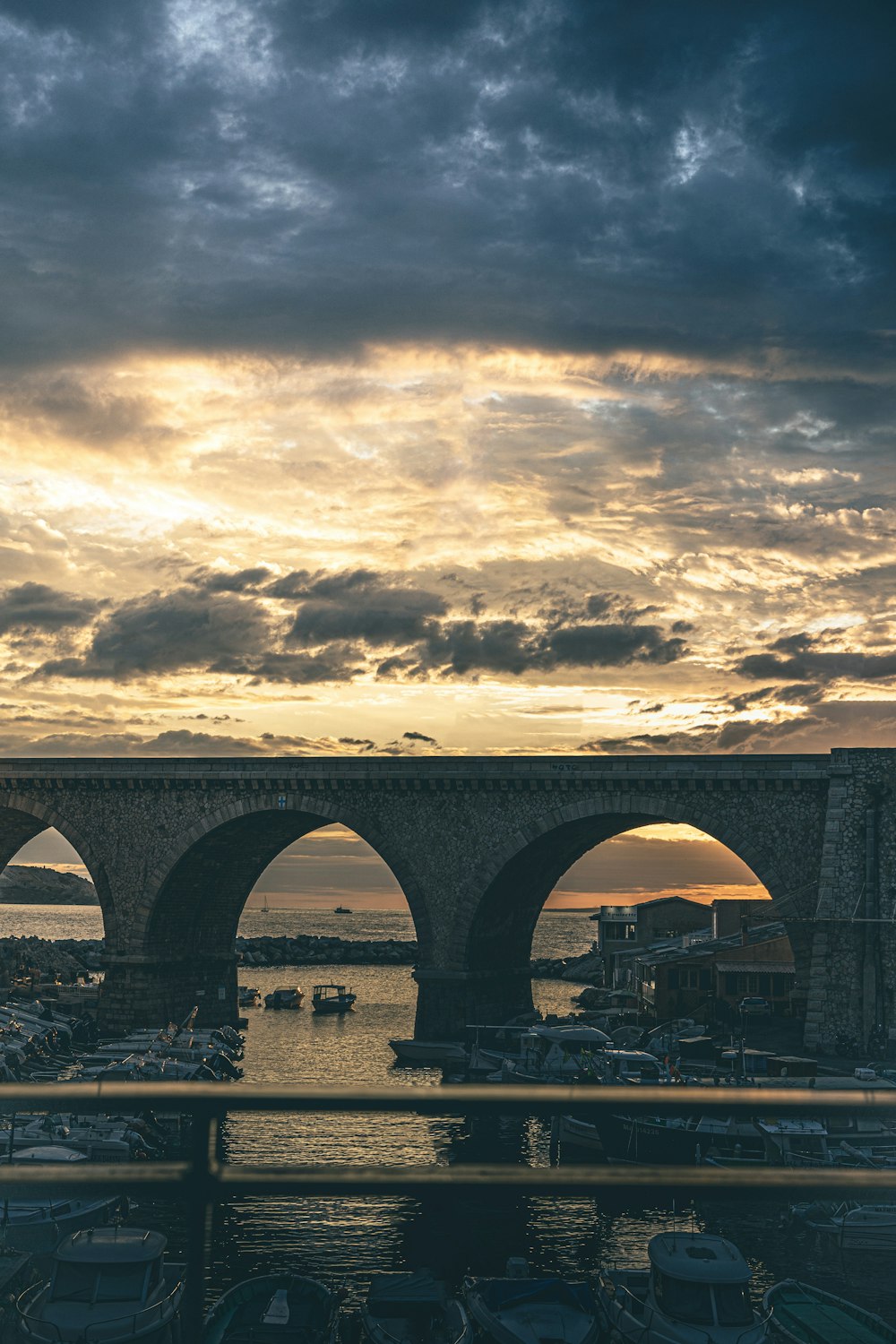 a bridge with a sunset in the background